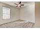Bedroom with neutral carpet, ceiling fan, and a large window at 112 Chelsea Place Ave, Ormond Beach, FL 32174