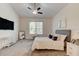 Serene bedroom with a ceiling fan, large window, and comfortable furnishings at 112 Chelsea Place Ave, Ormond Beach, FL 32174