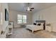 Bright bedroom with a ceiling fan, a large window, and neutral colors at 112 Chelsea Place Ave, Ormond Beach, FL 32174
