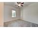 Bright bedroom with a ceiling fan, a large window, and neutral colors at 112 Chelsea Place Ave, Ormond Beach, FL 32174