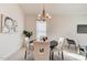 Elegant dining area featuring a modern chandelier and a round table with comfortable seating at 112 Chelsea Place Ave, Ormond Beach, FL 32174