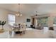 Open-concept dining area with tile floors, chandelier, and a seamless transition to outdoor living at 112 Chelsea Place Ave, Ormond Beach, FL 32174