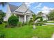 Charming home with manicured front yard, lush landscaping, and inviting curb appeal at 112 Chelsea Place Ave, Ormond Beach, FL 32174