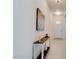 Bright hallway with a console table and artwork on the wall leading to the front door at 112 Chelsea Place Ave, Ormond Beach, FL 32174