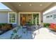 Comfortable covered patio with table and chairs, perfect for outdoor dining at 112 Chelsea Place Ave, Ormond Beach, FL 32174