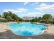 Bright community pool with brick trim, ample seating, and verdant landscaping under a sunny sky at 112 Chelsea Place Ave, Ormond Beach, FL 32174
