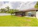 Spacious backyard with lawn, patio, grill and enclosed sunroom providing ample outdoor enjoyment at 1166 Tracy Dr, Port Orange, FL 32129