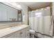 Updated bathroom featuring a vanity sink with storage, updated fixtures, and a shower at 1166 Tracy Dr, Port Orange, FL 32129