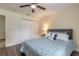 Comfortable bedroom featuring wood-look floors, closet, updated ceiling fan, and ample lighting at 1166 Tracy Dr, Port Orange, FL 32129