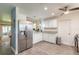 Modern kitchen features stainless refrigerator, granite countertops, and white cabinetry at 1166 Tracy Dr, Port Orange, FL 32129