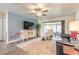 Bright living room with ceiling fan, leather sofa, and sliding door access to lanai at 1166 Tracy Dr, Port Orange, FL 32129