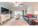 Cozy living room with comfy leather sofa, TV, and access to a screened lanai at 1166 Tracy Dr, Port Orange, FL 32129