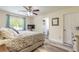 Comfortable primary bedroom with wood-look floors, ceiling fan and ensuite bath at 1166 Tracy Dr, Port Orange, FL 32129