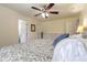 Spacious main bedroom featuring wood-look floors, an updated fan, and natural lighting at 1166 Tracy Dr, Port Orange, FL 32129