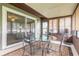Enclosed sunroom with lots of natural light, table, chairs, and a neutral colored rug at 1166 Tracy Dr, Port Orange, FL 32129