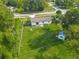 Aerial view of a house with a big, green backyard, including a shed, enclosed by a chain-link fence at 1203 W 20Th St, Sanford, FL 32771