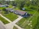 Charming home with a fenced yard, a small storage shed, and a peaceful wooded backdrop in an aerial shot at 1203 W 20Th St, Sanford, FL 32771