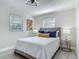 Cozy bedroom featuring neutral walls, decorative lamps, decorative pillows, and light wood-look flooring at 1203 W 20Th St, Sanford, FL 32771