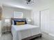 Nicely appointed bedroom with modern lighting, light gray wood-look flooring, and closet at 1203 W 20Th St, Sanford, FL 32771