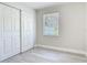 Bedroom boasts a neutral palette, wood-look floors, and a spacious closet for ample storage at 1203 W 20Th St, Sanford, FL 32771