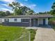 Well-maintained single-story house with a gray accent wall and a covered carport for convenient parking at 1203 W 20Th St, Sanford, FL 32771