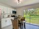 Cozy eat-in kitchen with stainless appliances, white cabinets, and a view to the backyard at 1203 W 20Th St, Sanford, FL 32771