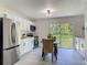 Bright kitchen with stainless steel appliances, white cabinetry, and a breakfast nook by the window at 1203 W 20Th St, Sanford, FL 32771