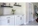 Bright kitchen features white cabinets, black hardware, floating shelves, quartz counters, and subway tile backsplash at 1203 W 20Th St, Sanford, FL 32771
