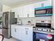 Well-equipped kitchen featuring stainless steel appliances, white cabinets, and modern fixtures at 1203 W 20Th St, Sanford, FL 32771