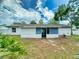 Back of home featuring a screened in porch with a spacious grassy yard at 1229 Jeffery Dr, Port Orange, FL 32129