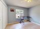 Well-lit bedroom with tile floors, a window view, closet, and room for a keyboard at 1229 Jeffery Dr, Port Orange, FL 32129