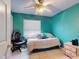A cozy bedroom featuring a ceiling fan and a view of the neighborhood at 1229 Jeffery Dr, Port Orange, FL 32129