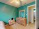 Bedroom features bright teal walls, ceiling fan, and a view of ensuite bathroom at 1229 Jeffery Dr, Port Orange, FL 32129