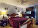 Cozy bedroom featuring a ceiling fan and comfortable bedding and a large television at 1229 Jeffery Dr, Port Orange, FL 32129