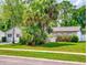 Charming home featuring a well-manicured lawn and mature trees in a suburban neighborhood at 1229 Jeffery Dr, Port Orange, FL 32129