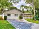 Charming one-story home with a stone exterior and a well-maintained front yard with a concrete driveway at 1229 Jeffery Dr, Port Orange, FL 32129