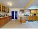 Spacious kitchen with light wood cabinets, tile floors, skylight and an island at 1229 Jeffery Dr, Port Orange, FL 32129