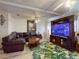 Spacious living room with leather seating, a television, and a tropical rug at 1229 Jeffery Dr, Port Orange, FL 32129