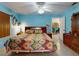 The primary bedroom features tile floors, blue walls, and a ceiling fan at 1229 Jeffery Dr, Port Orange, FL 32129