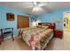 A spacious main bedroom featuring cool blue walls and a ceiling fan at 1229 Jeffery Dr, Port Orange, FL 32129