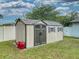 Well-maintained outdoor storage shed with double doors and a window at 1229 Jeffery Dr, Port Orange, FL 32129