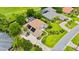 Stunning aerial view of a home with a tile roof, solar panels, and lush landscaping near a golf course at 1324 Dovercourt Ln, Ormond Beach, FL 32174