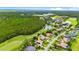 Detailed aerial perspective of a home with a tile roof and landscaping, adjacent to a golf course at 1324 Dovercourt Ln, Ormond Beach, FL 32174
