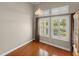 Bright bedroom features hardwood floors and windows with plantation shutters at 1324 Dovercourt Ln, Ormond Beach, FL 32174