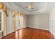 Bright bedroom with hardwood floors, ceiling fan, and a double french door exit at 1324 Dovercourt Ln, Ormond Beach, FL 32174