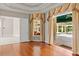 Elegant bedroom with hardwood floors and large windows overlooking the pool area at 1324 Dovercourt Ln, Ormond Beach, FL 32174