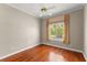 Bedroom featuring hardwood floors, large window, and neutral paint at 1324 Dovercourt Ln, Ormond Beach, FL 32174
