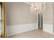 Formal dining area featuring a chandelier, decorative molding, and neutral paint for an elegant ambiance at 1324 Dovercourt Ln, Ormond Beach, FL 32174