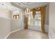Formal dining area showcasing elegant lighting, window shutters, decorative molding, and a tray ceiling design at 1324 Dovercourt Ln, Ormond Beach, FL 32174