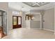 Elegant foyer with tile floors, a decorative chandelier, double-door entryway, and transom windows for natural light at 1324 Dovercourt Ln, Ormond Beach, FL 32174